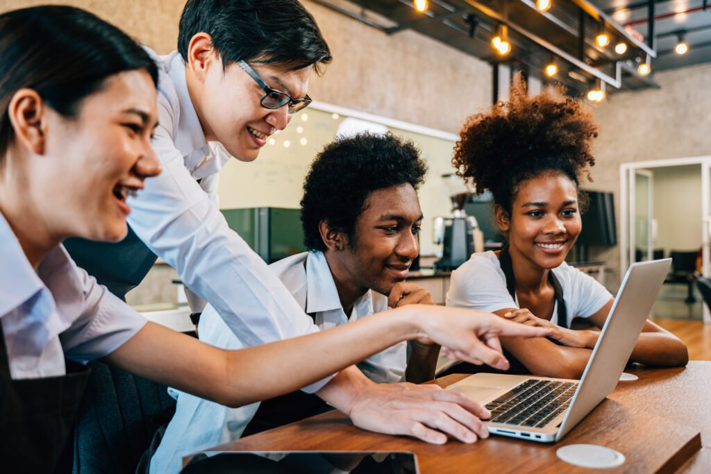 Small business team collaborating over coffee, representing how trust fuels referrals and lasting partnerships.